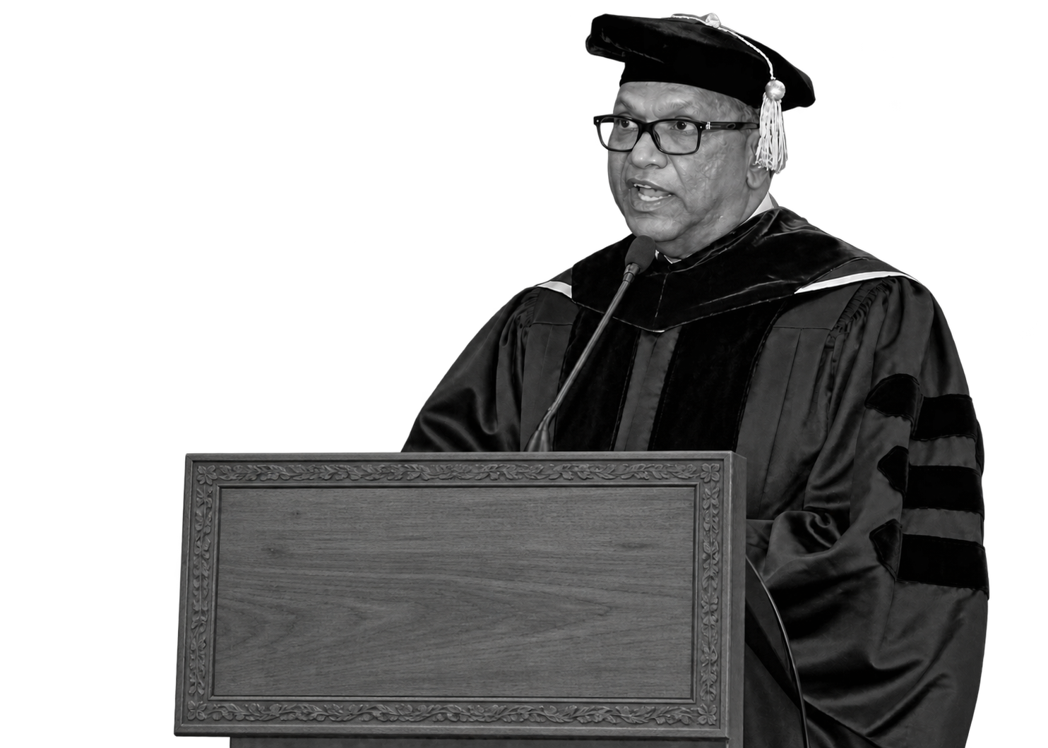 Dr Balakrishna Grandhi speaking in academic robes at a lectern